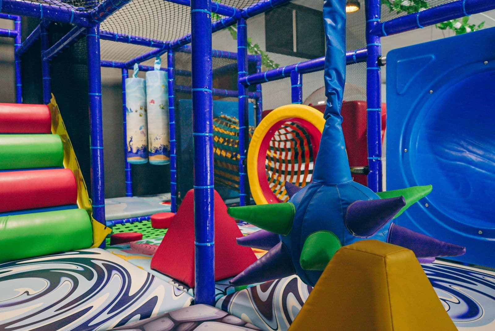 Soft play shapes on the padded floor under the tower