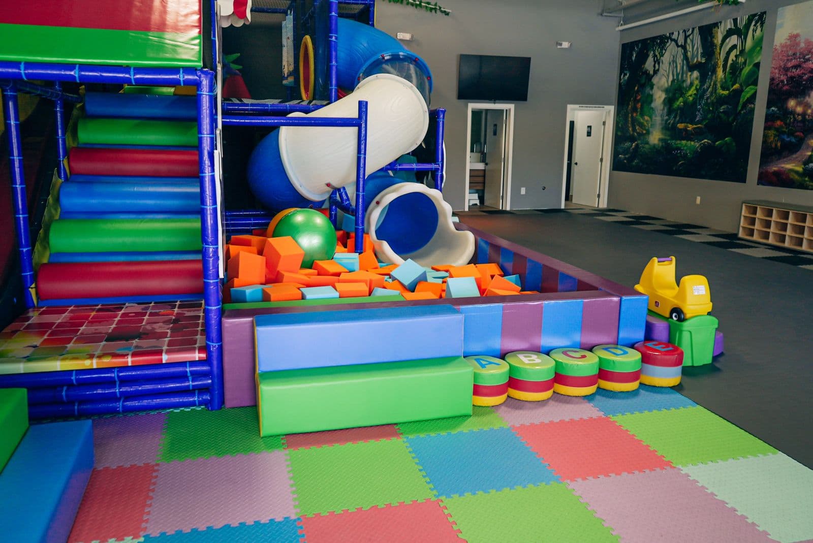 The climbing structure with its tube slide and the soft play blocks