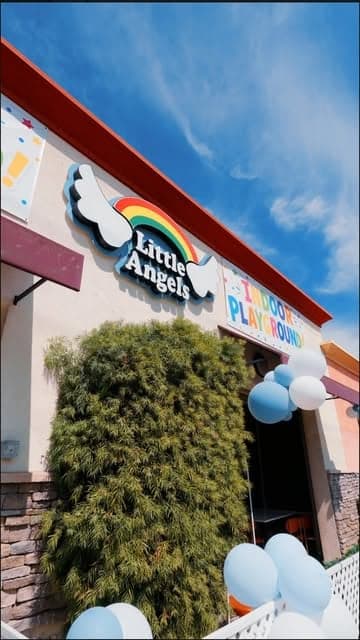 The Little Angels sign over the entrance with balloons